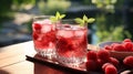 Two glasses with raspberries and ice on wooden table at summer garden Royalty Free Stock Photo