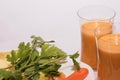 Two glasses of freshly juice of carrots, apples, oranges and parsley Royalty Free Stock Photo