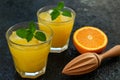 Two glasses of freshly squeezed orange juice on a black background. Close-up. Royalty Free Stock Photo