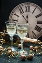 Glasses of champagne with bottle on color background, selective focus