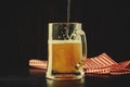 Two glasses of german light beer, beer poured into mug, dark bar Royalty Free Stock Photo