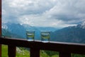 Two glasses of grappa on the wooden railing of the mountain hote terrace