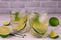 Two glasses with green tea with lime and ice on a white background. Royalty Free Stock Photo