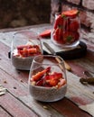 Two glasses with homemade super food chia pudding with cut strawberries