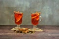 Two glasses of hot red wine with spices on napkins stand on a wooden table Royalty Free Stock Photo