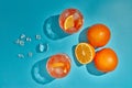 Two glasses with ice and oranges on blue background with shadow. Top view. Cocktail. Fresh orange juice Royalty Free Stock Photo