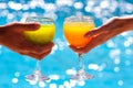 Two glasses with juice against blue water Royalty Free Stock Photo