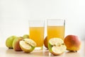 Two 2 glasses of juice, Apple juice, whole apples and apples cu Royalty Free Stock Photo