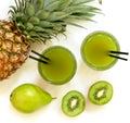 Two glasses of kiwi, pineapple, pear juice isolated on white and ingredients. Royalty Free Stock Photo