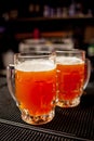 Two glasses of lager on a black background Royalty Free Stock Photo