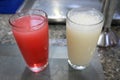 Two glasses of lemonade on the table. Strawberry and creamy lemonade in a clear glass.