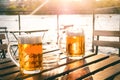 Two glasses of light beer with foam on a wooden table.On a boat. Garden party. Natural background. Alcohol. Draft beer. Landscape,