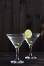 Two glasses margarita cocktail in the bar. martini glasses of cocktail with olives on wooden background. Royalty Free Stock Photo