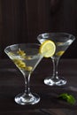 Two glasses margarita cocktail in the bar. martini glasses of cocktail with olives on wooden background. Royalty Free Stock Photo