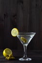 Two glasses margarita cocktail in the bar. martini glasses of cocktail with olives on wooden background. Royalty Free Stock Photo