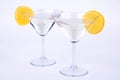 Two glasses of martini and lemon on blue