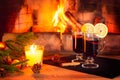 Two glasses with mulled wine, a candle, fir branches with decorations on a wooden table against the background of a Royalty Free Stock Photo