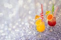 Two glasses with orange and grapefruit juice with ice and citrus slices stand on a gray shiny background Royalty Free Stock Photo