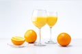 Two glasses of orange juice and fruits on light grey background. Royalty Free Stock Photo