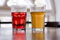 Two glasses with orange juice and pomegranate juice are on the table in a cafe. healthy drinks, smoothies, citro and lemonade clos Royalty Free Stock Photo