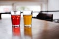 Two glasses with orange juice and pomegranate juice are on the table in a cafe. healthy drinks, smoothies, citro and lemonade clos Royalty Free Stock Photo