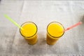 Two glasses of orange juice on sackcloth background. Healthy drink concept. Royalty Free Stock Photo