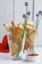 Two glasses with phyllo triangles pies with feta and spinach Royalty Free Stock Photo