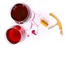 Two glasses of pink red wine, corkscrew, bottle opener  on white background with Traces of wine. Free copy space. Royalty Free Stock Photo