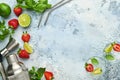 Two glasses of punch and fresh ingredients for making lemonade, infused detox water or cocktail. Strawberries, lime, mint, basil, Royalty Free Stock Photo