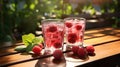 Two glasses with raspberries and ice on wooden table at garden Royalty Free Stock Photo