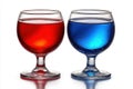 Two glasses of red and blue liquid on white background Ai photo Royalty Free Stock Photo