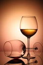 Two glasses with red and white wine, on a bright, colorful background, in backlight Royalty Free Stock Photo