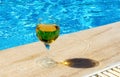 Two glasses of red and white wine are placed by the pool. The concept of a pleasant stay. Royalty Free Stock Photo