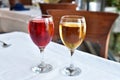 Two glasses with red and white wine stand on the table Royalty Free Stock Photo