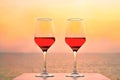 Two glasses of red wine on the background of the sea. Royalty Free Stock Photo