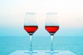 Two glasses of red wine on the background of the sea. Royalty Free Stock Photo