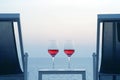 Two glasses of red wine on the background of the sea. Royalty Free Stock Photo