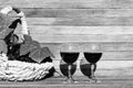 Two glasses of red wine and a basket of grapes on a wooden background on a Sunny day with a copy of the space, black and white pho Royalty Free Stock Photo