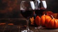 Two glasses of red wine with a bottle of wine in the background Royalty Free Stock Photo
