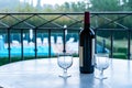 Two glasses of red wine and bottle on the balcony Royalty Free Stock Photo