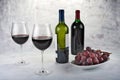 Two glasses of red wine with bottle and grapes. Royalty Free Stock Photo