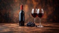 Two glasses with red wine, wine bottle and red grapes, copy space. Royalty Free Stock Photo