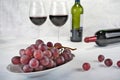 Two glasses of red wine with bottle and grapes. Royalty Free Stock Photo