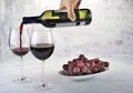 Two glasses of red wine with bottle and grapes. Royalty Free Stock Photo