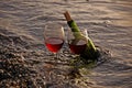 Two Glasses Red Wine and Bottle in Ocean Royalty Free Stock Photo