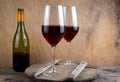 Two glasses of red wine. The bottle of wine is on the table. Wine background. Still life. Alcoholic drink in a glass. Wooden Royalty Free Stock Photo