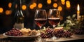 Two glasses of red wine, a bottle of wine, grapes, candles against a background of festive golden bokeh Royalty Free Stock Photo