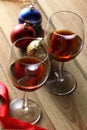 Two glasses of red wine and Christmas ornament on a wooden table with copy space for your text Royalty Free Stock Photo