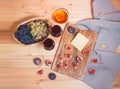 Two glasses of red wine, fig, cheese, bunches of grape and honey on wooden table Royalty Free Stock Photo
