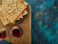 Two glasses of red wine and matzo are on the table on a simple canvas napkin. View from above. The holiday of the Jewish Passover Royalty Free Stock Photo